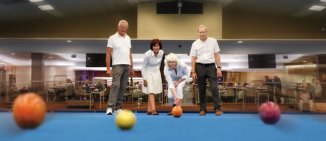Couples playing bowls